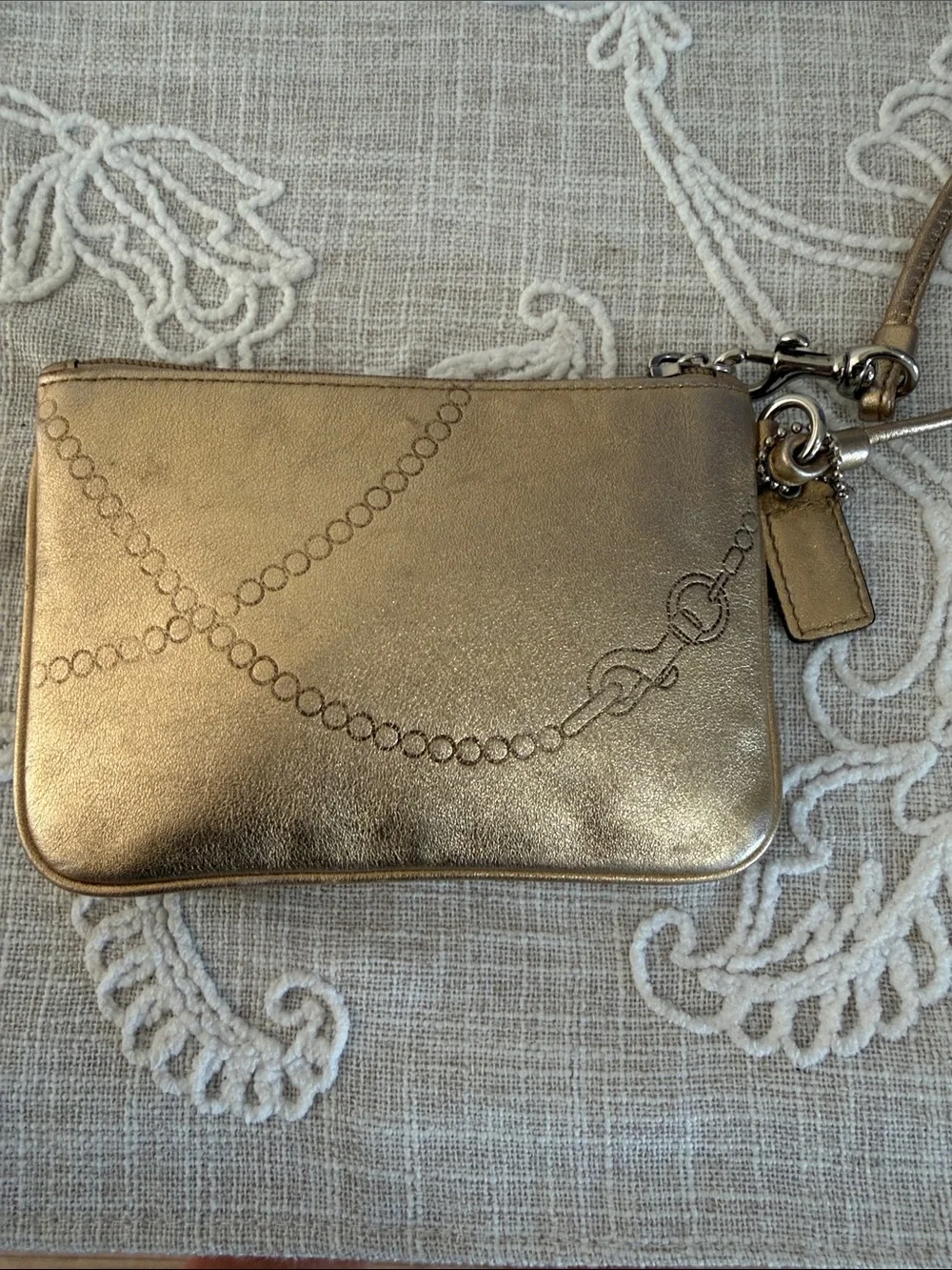 Coach Metallic Gold Wristlet with Embossed Chain Motif